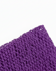 Close-up of a textured purple fabric on a white background