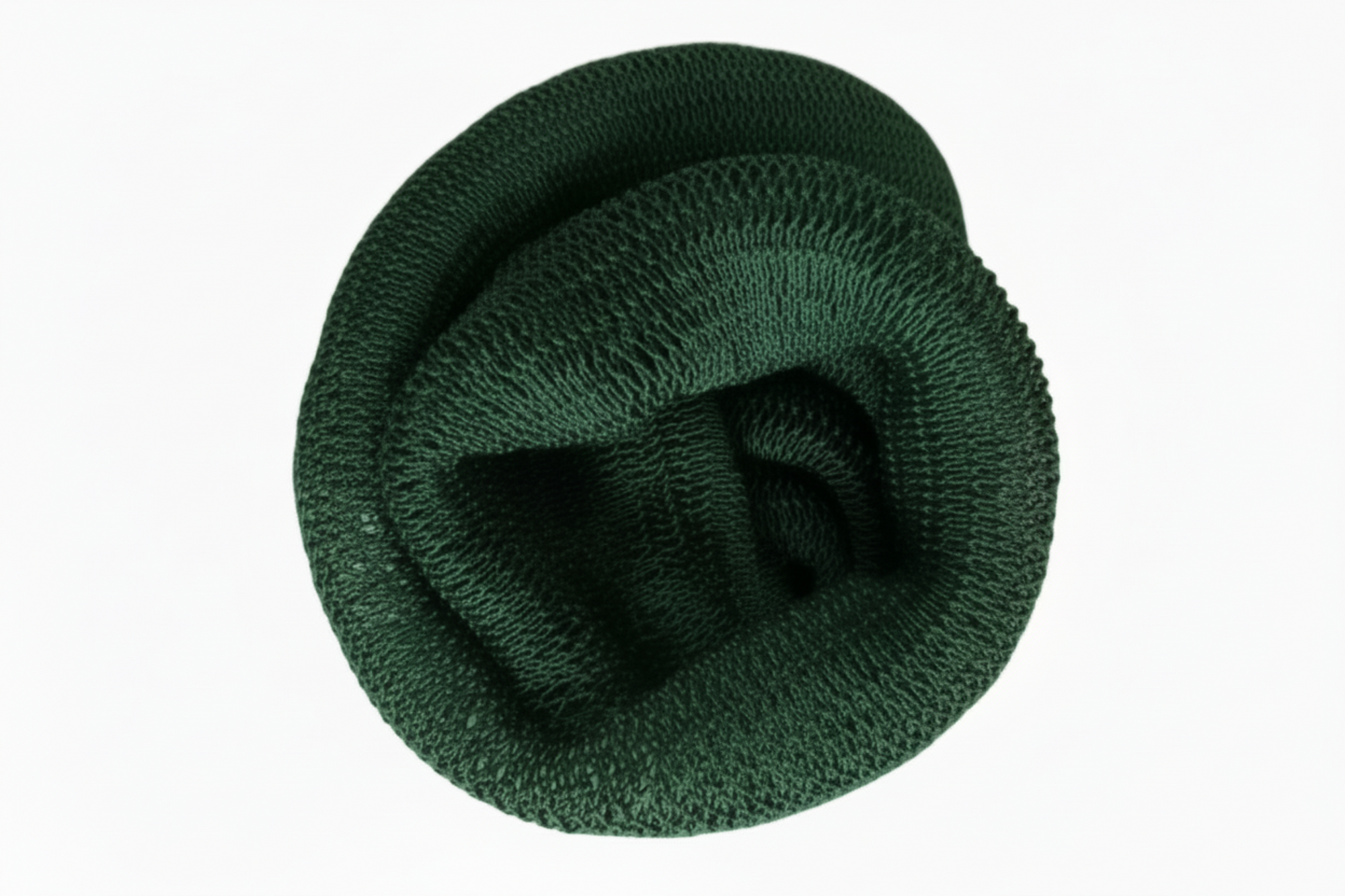 Green knitted scarf coiled up on a white background