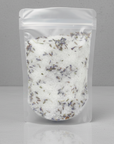 Clear plastic bag with bath salts on a gray background