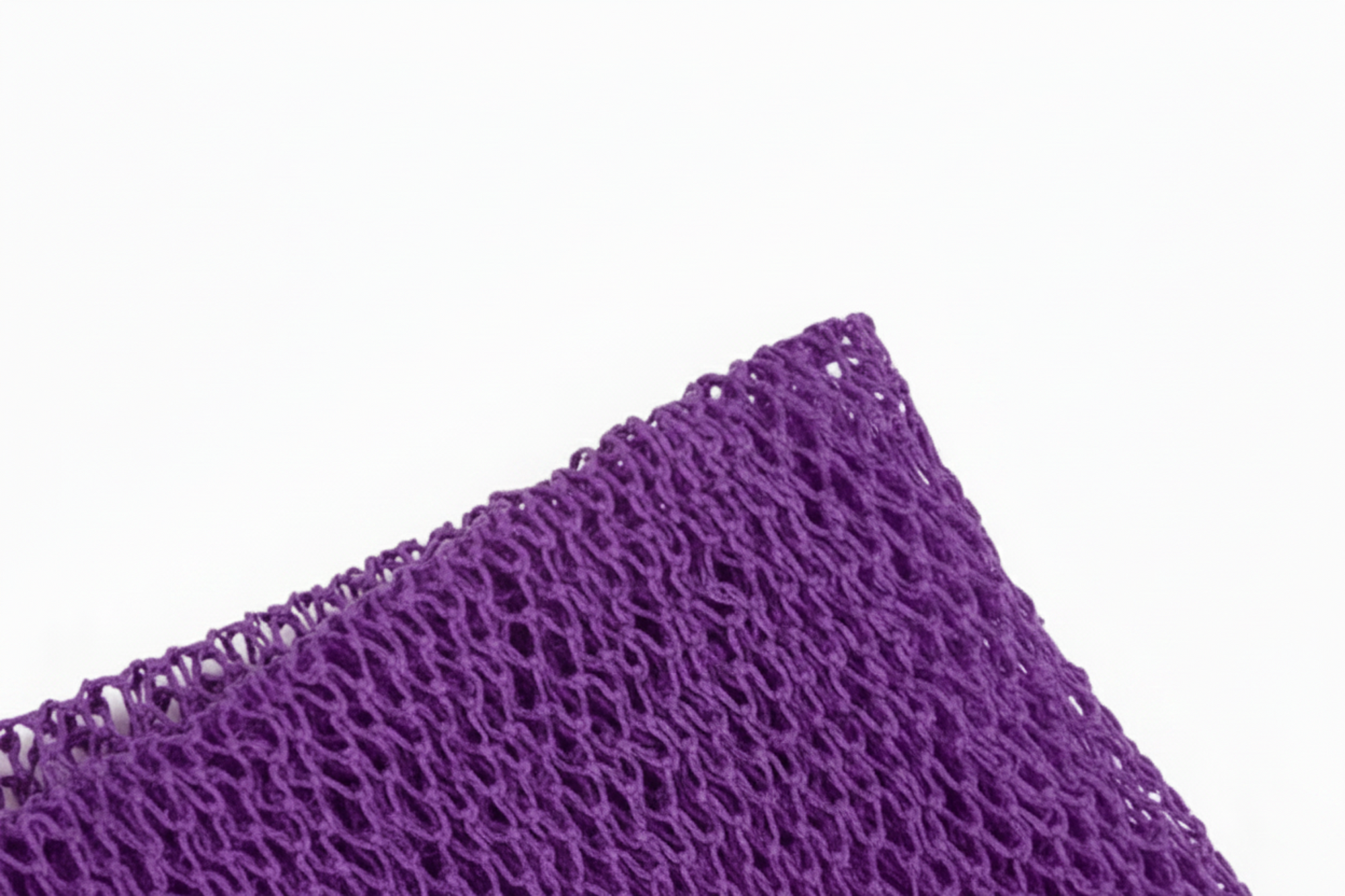 Close-up of a textured purple fabric on a white background