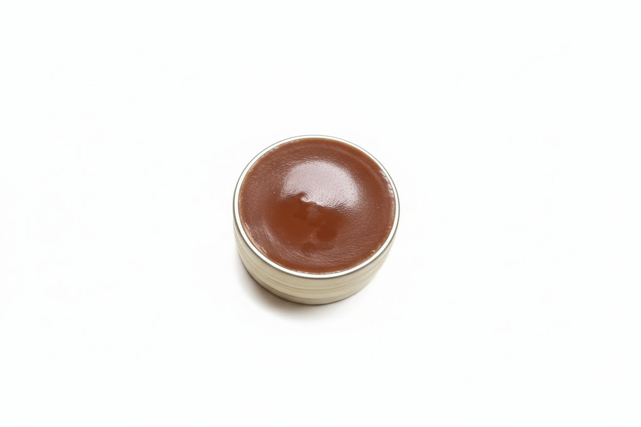 Small container of Chocolate lip balm on a white background