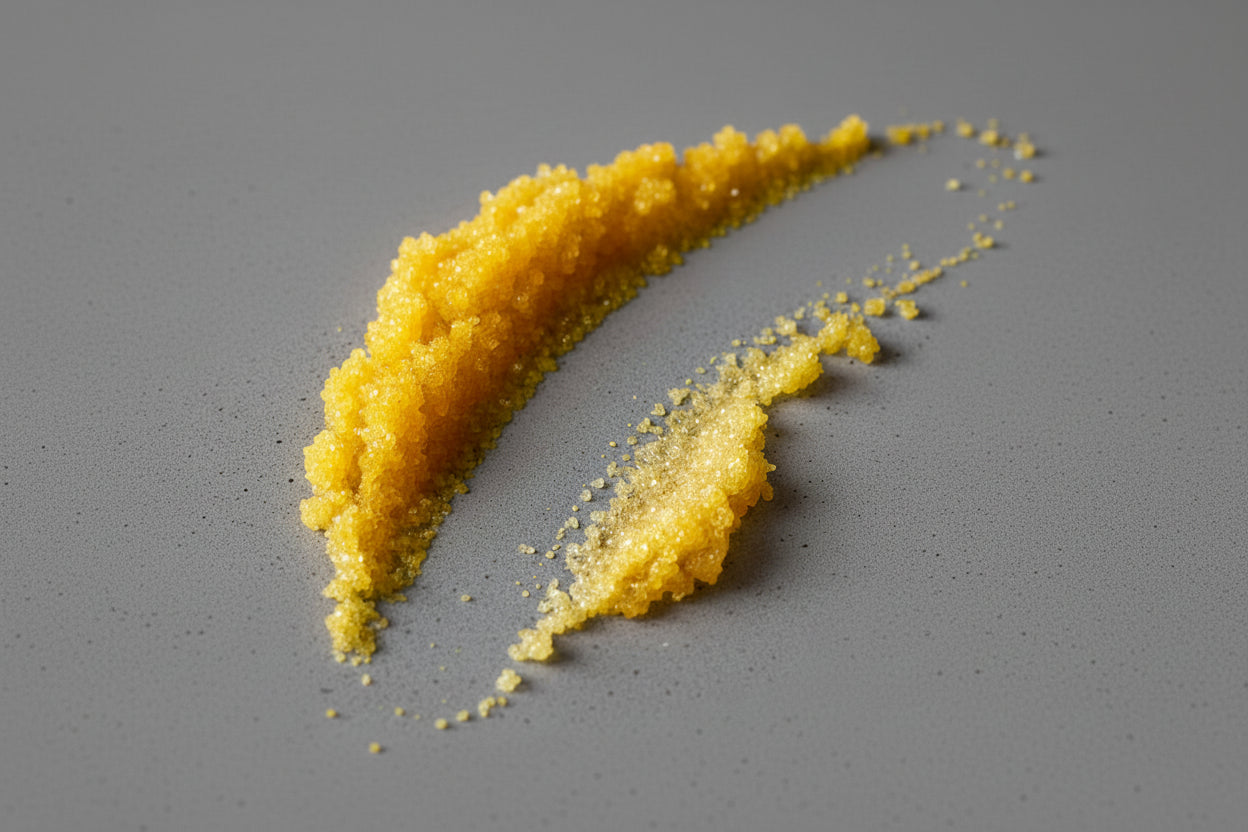 Turmeric lip scrub smeared on a gray background