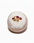 Round white trinket box with floral design on a white background